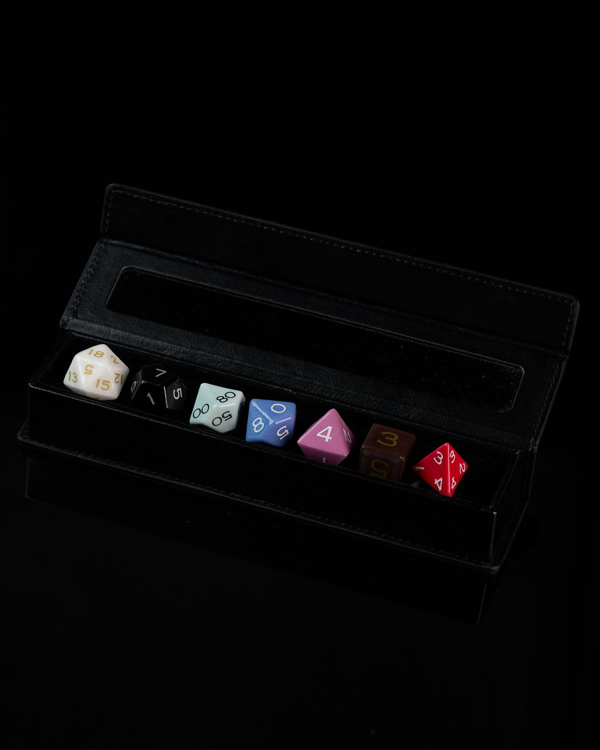 A complete colorful ceramic dice set presented in a fitted black display case