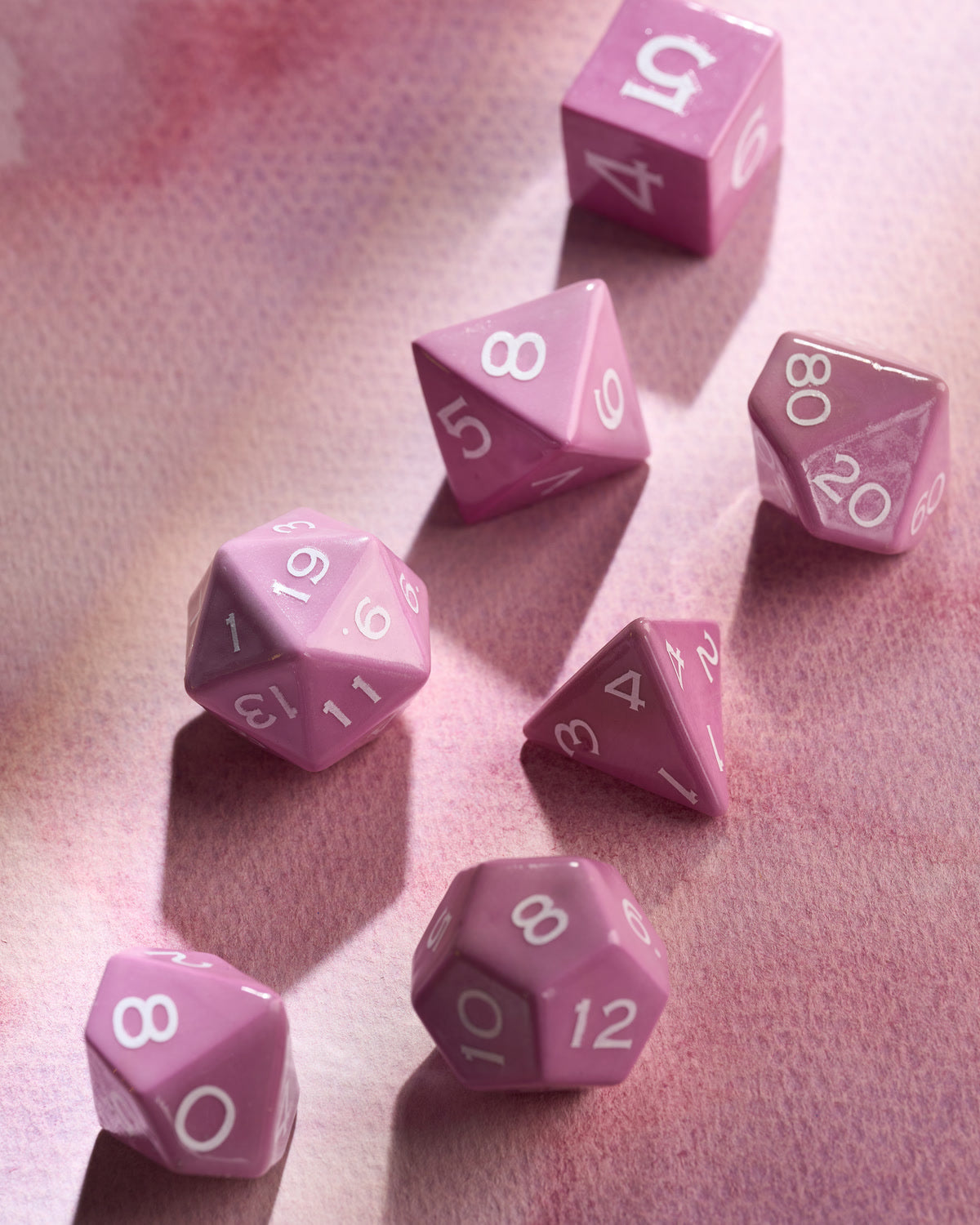 Glossy purple ceramic dice reflecting soft directional light